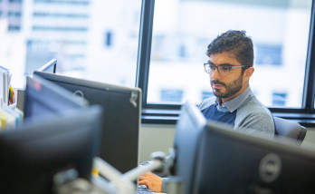 man with monitors in office